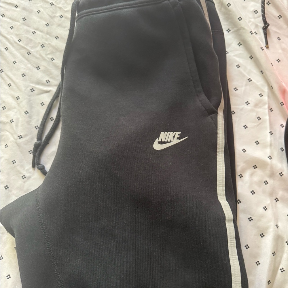Two pairs of Nike Black Joggers with White Side Stripe and black and red